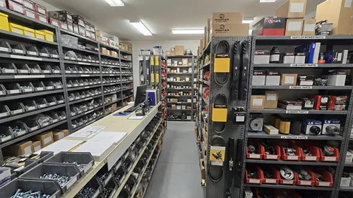 Well-organized parts room stocked with lawn mower parts, belts, and filters